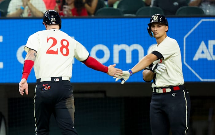 Jul 15, 2023; Arlington, Texas, USA; Texas Rangers catcher Jonah Heim (28) celebrates with teammates Texas Rangers shortstop Corey Seager (5) after scoring during the second inning against the Cleveland Guardians at Globe Life Field. Mandatory Credit: Kevin Jairaj-USA TODAY Sports